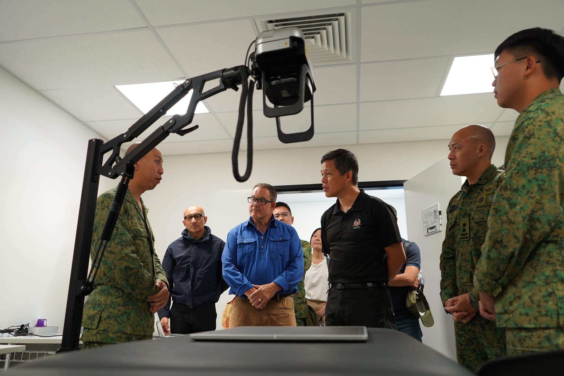 Mr Chan (third from right) and Mr Gosling (third from left) toured facilities in Camp Tilpal.